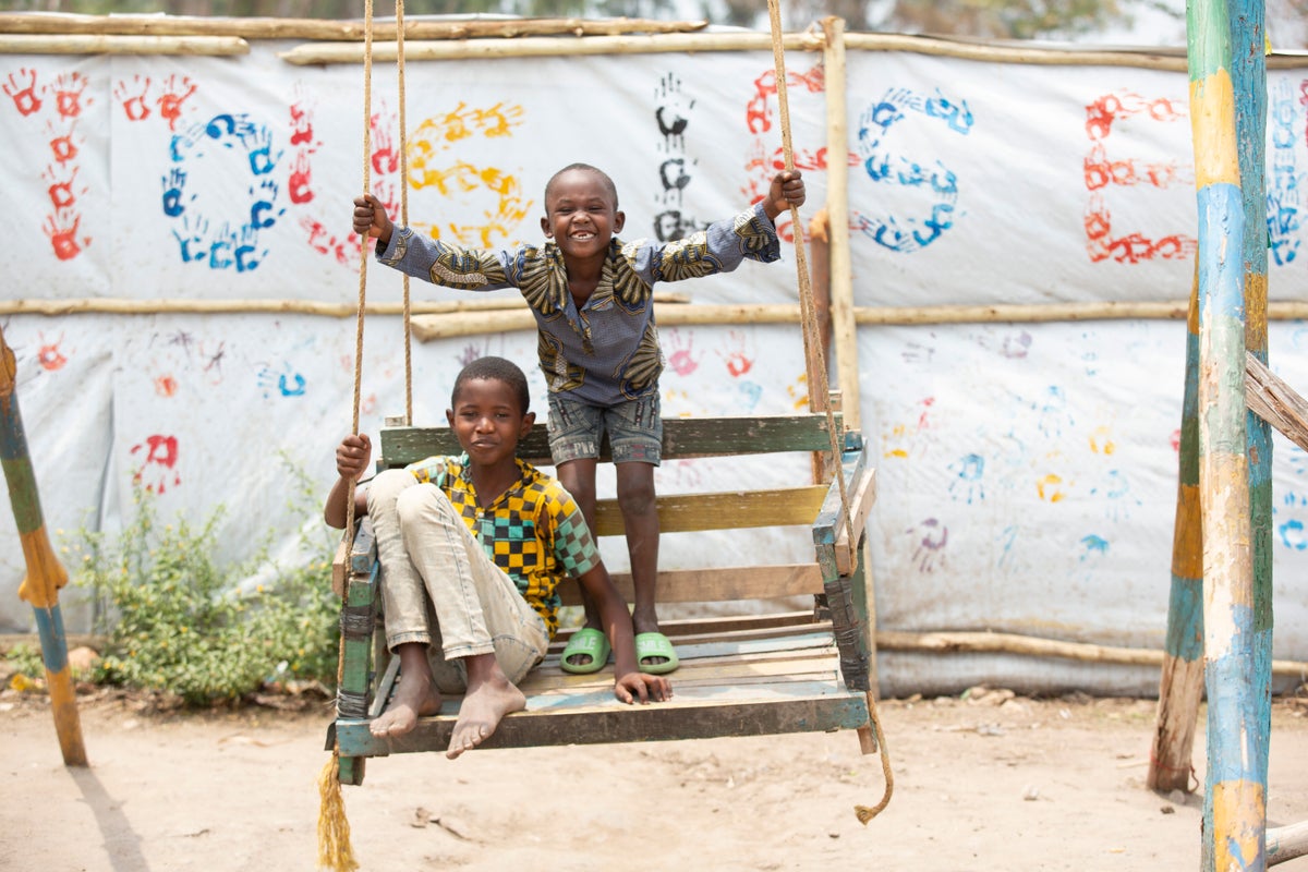 Children playing on a swing in an IDP (internally displaced people) camp.  