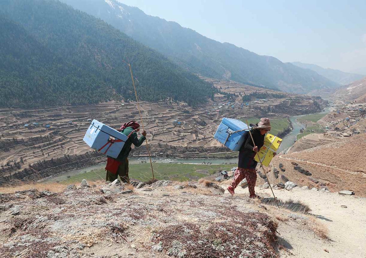 Porters carrying COVID-19 vaccines to health facilities in Jumla District in Nepal’s remote far-west region. 
