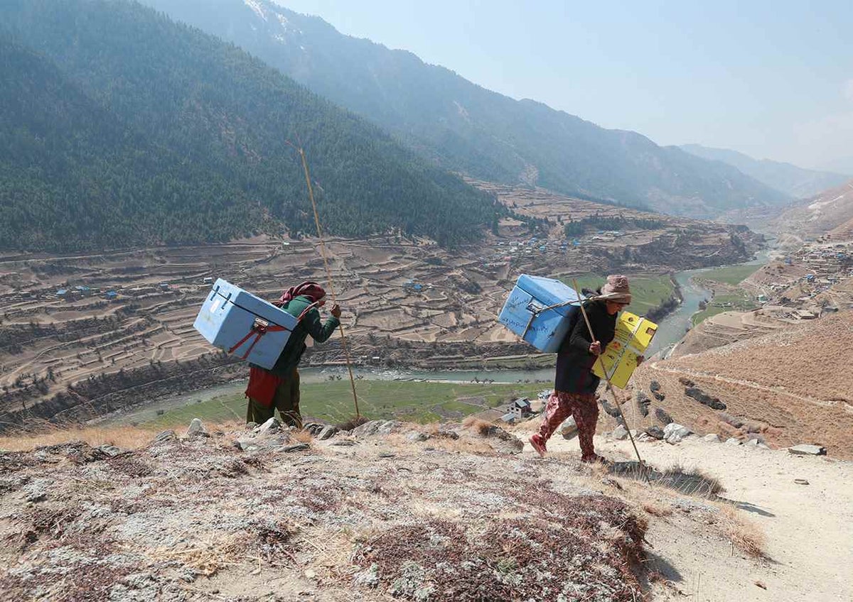Porters carrying COVID-19 vaccines to health facilities in Jumla District in Nepal’s remote far-west region.