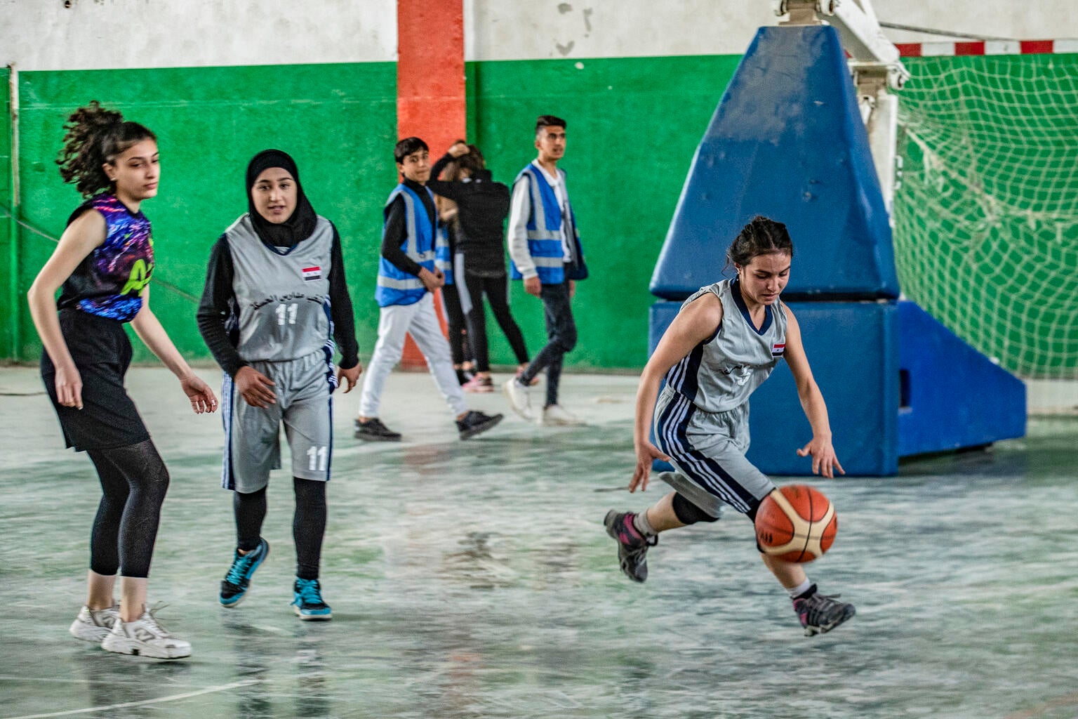 Syrian girls playing basketball at a UNICEF sports for development program