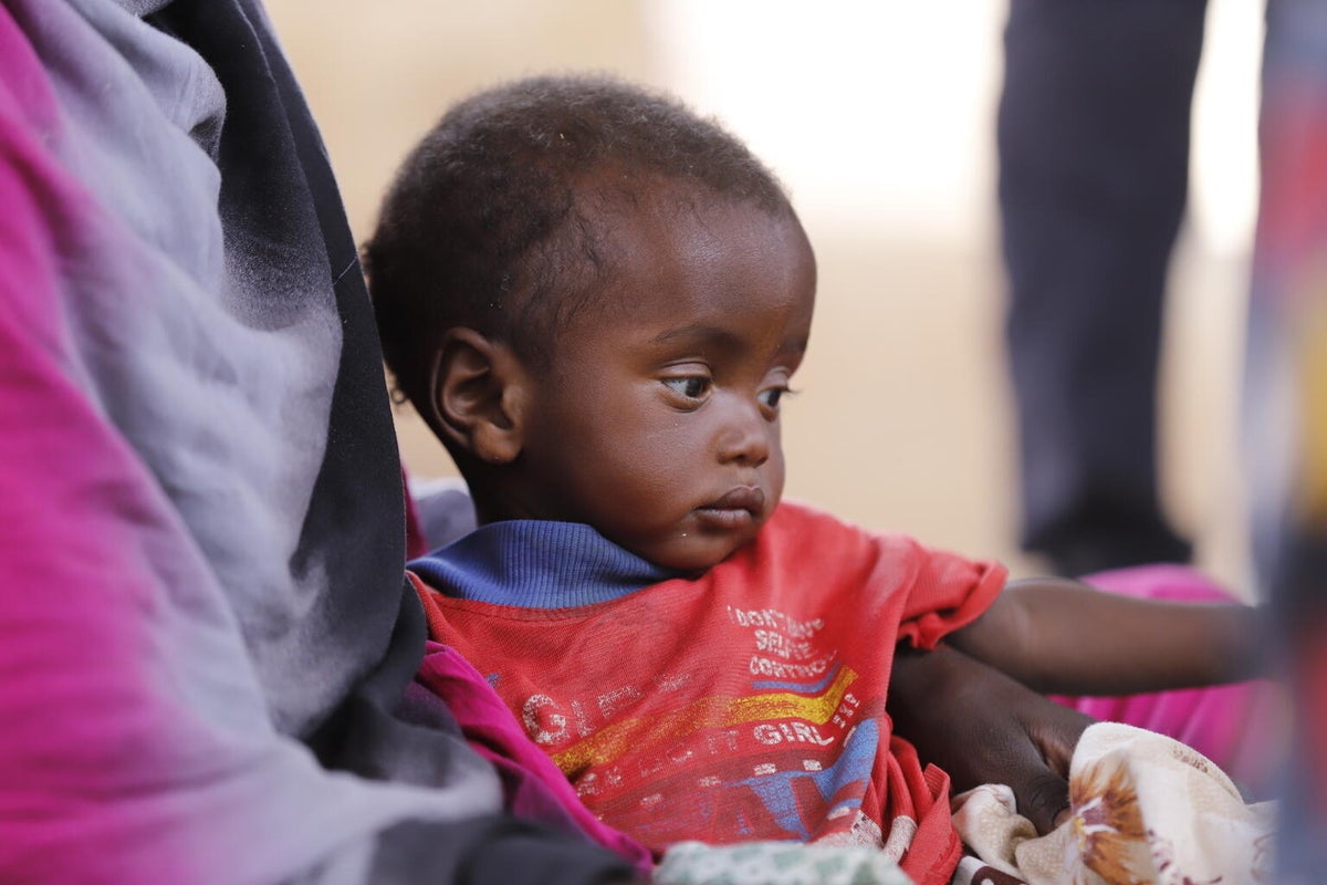 Health workers screen children for malnutrition at a UNICEF-supported nutrition clinic located at a camp for internally displaced people in North Darfur.