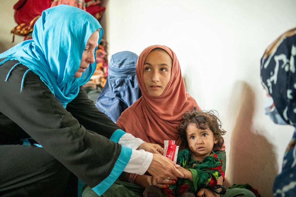 Health worker with mother and her child