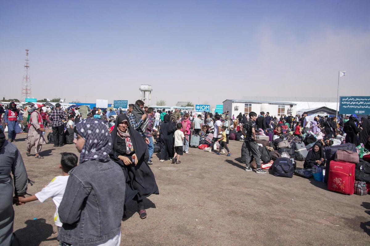 Afghan returnees from Iran gather at the Islam-Qala Border, in western Afghanistan. In June alone, on average, up to 20,000 people arrived at the border crossing daily towards the end of the month. 