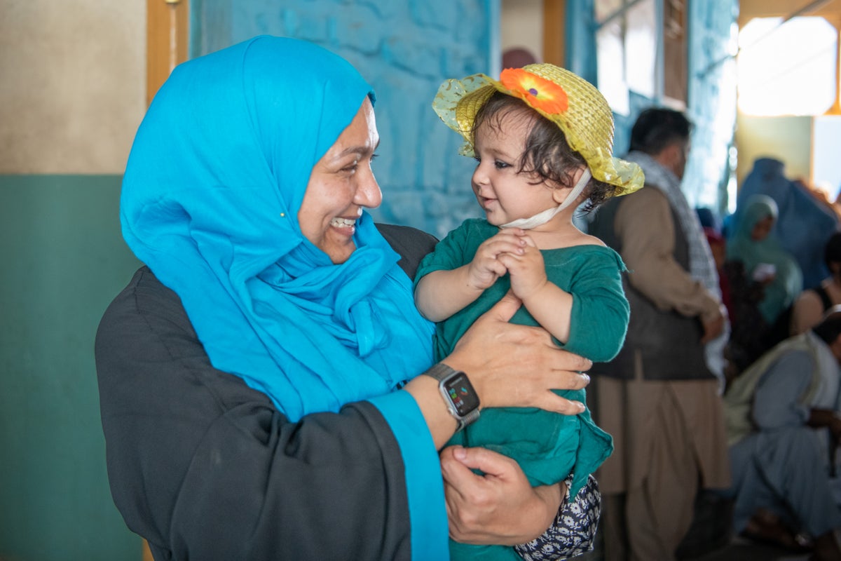 Woman in hijab hold a child