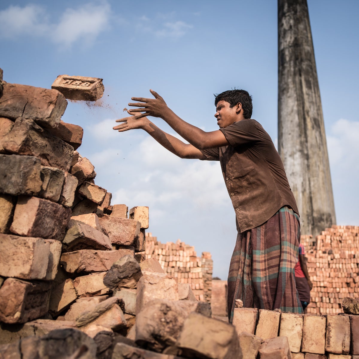 Teenage boy working in a brick field in Bangladesh.