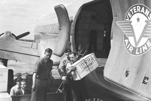 In Czechoslovakia, 1946, workers unload a shipment of 60,000 hatching eggs from a Veterans' Air Lines aeroplane in Prague, the capital. The eggs were donated to UNRRA (later UNICEF) as food aid. © UNICEF/UNI41888/Unknown 