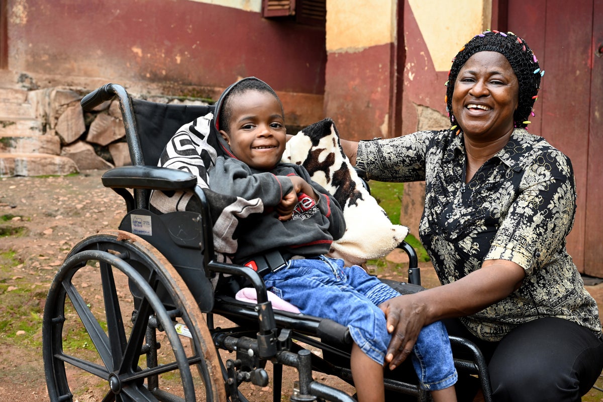 Child in wheelchair with their caregiver