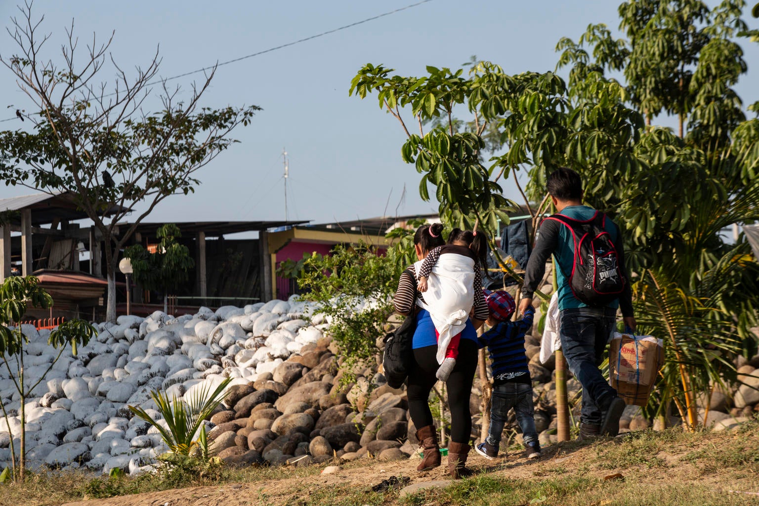 A family is about to cross a river in the Mexico-Guatemala border