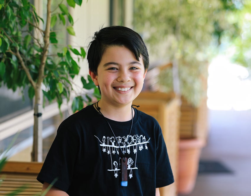 A young primary school student smiling at the camera