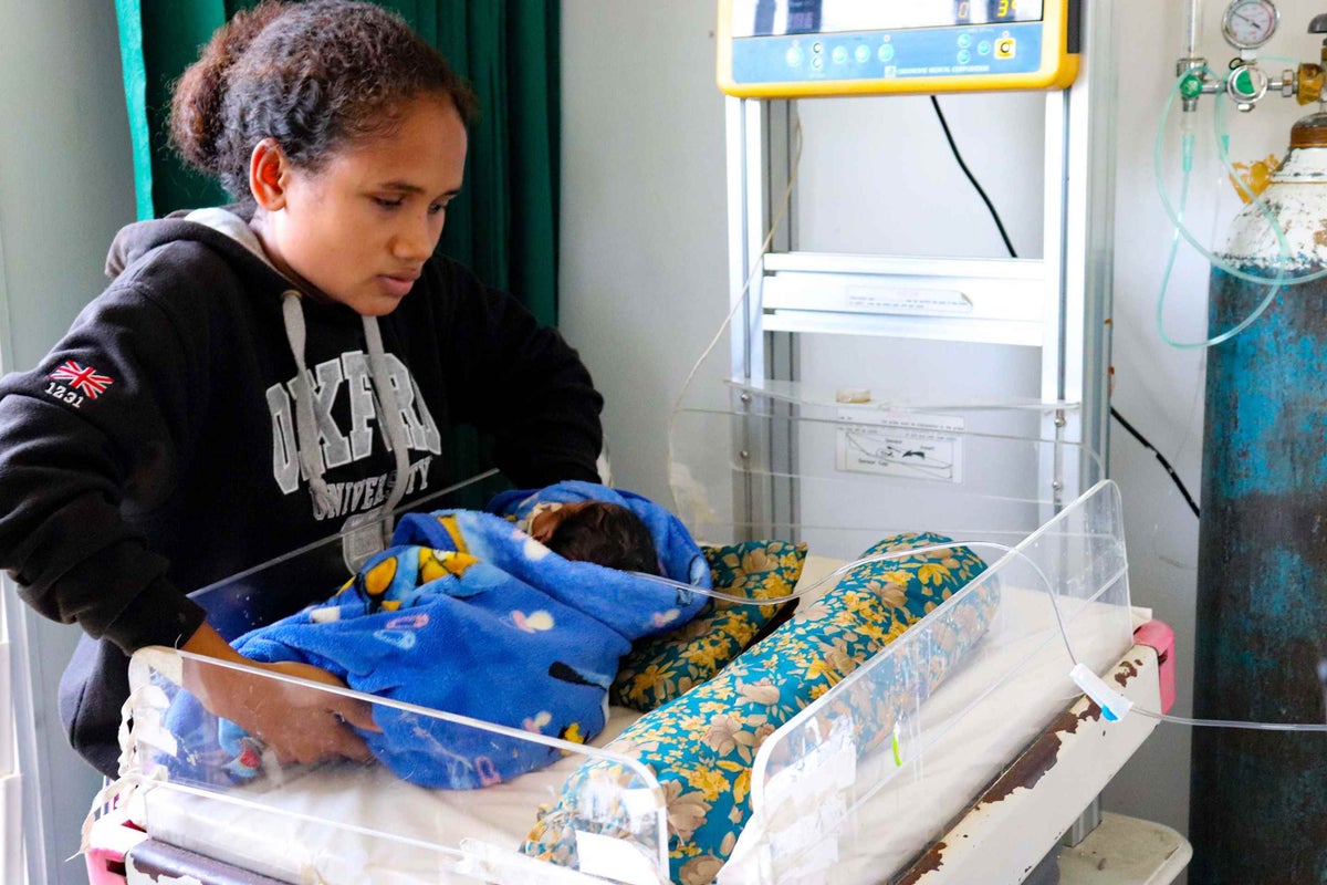 Mum Zulmira comforts her sick baby boy Apriliano (3 weeks) at the Baucau Regional Hospital in Timor-Leste