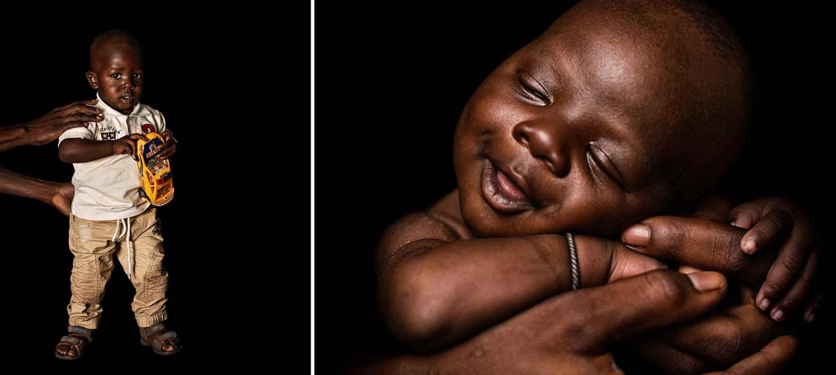 Aboubacar, 36, holds up his son Youssouf, 1, as he tries to position him for a photograph at the UNICEF-supported community health centre in Sikasso Region, Mali