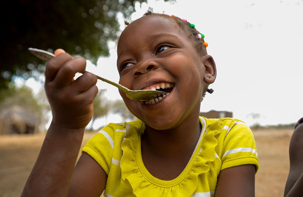 Child consuming nutritious food supplied by UNICEF 