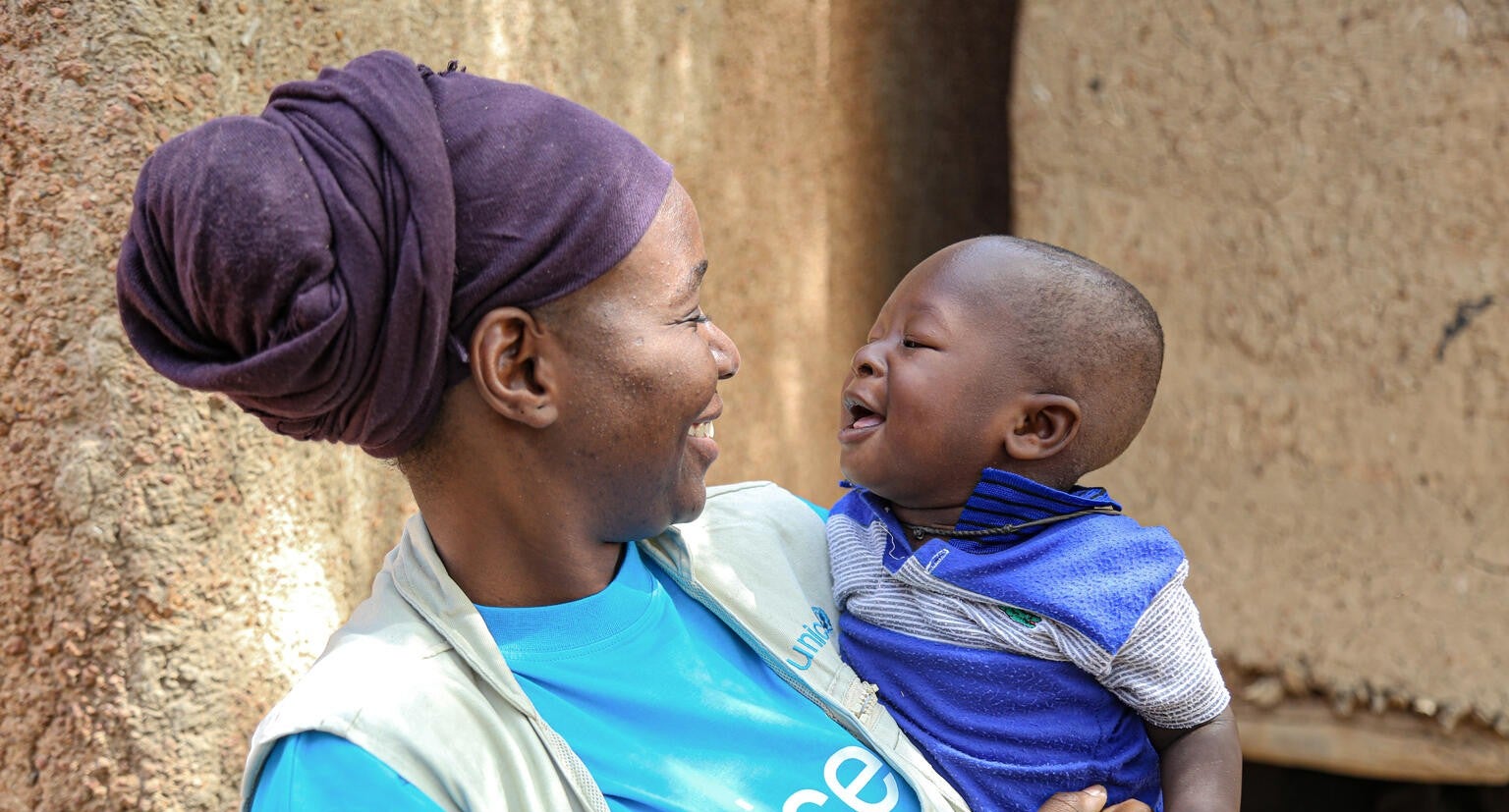 A UNICEF Emergency Specialist and a nine-month-old in a village in Mali.