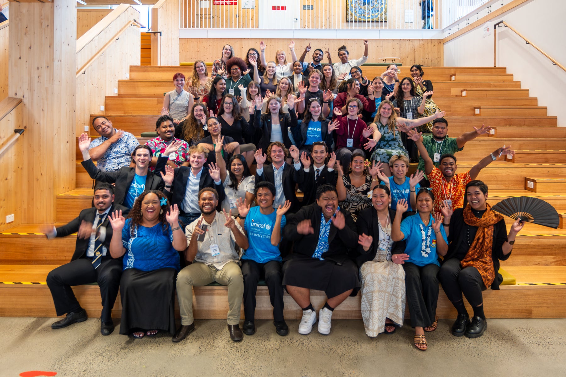 A large group of young people from Australia and the Pacific who attended the 2025 Dialogue pose for a fun group photo.
