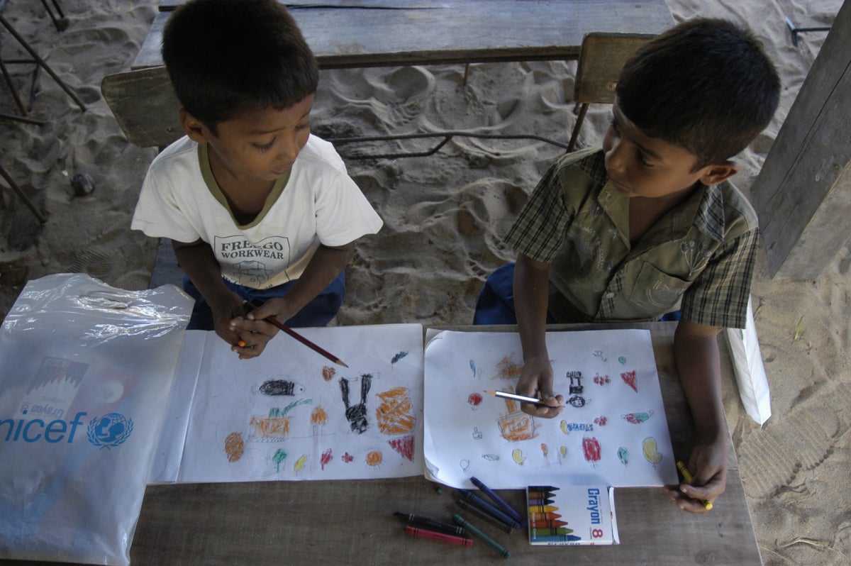 Grade 2 students draw and colour in a class in Sri Lanka with school-in-a-box supplies UNICEF provided to children affected by the Indian Ocean tsunami that hit the region on 26 December 2004."