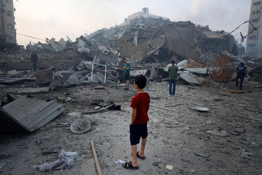 A 9-year-old boy stands in front of buildings that’s been turned to rubble in Gaza City. 