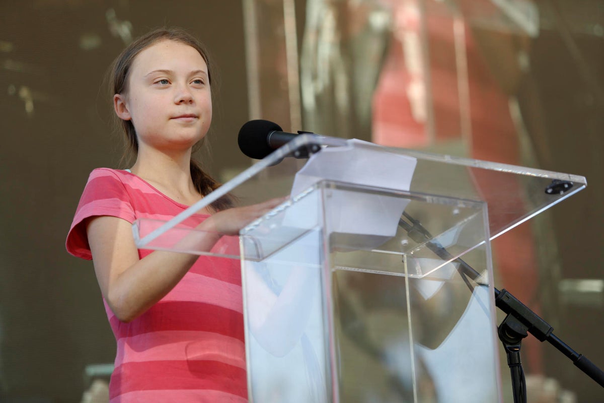 Photo of Greta Thurnberg behind a lectern ready to deliver a speech.