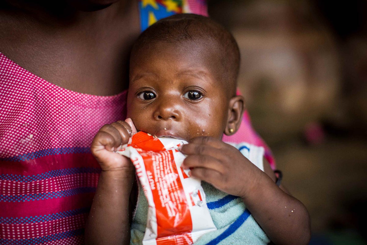 Aissata enjoying her Plumpy'Nut therapeutic food treatment at her home in Mali. 