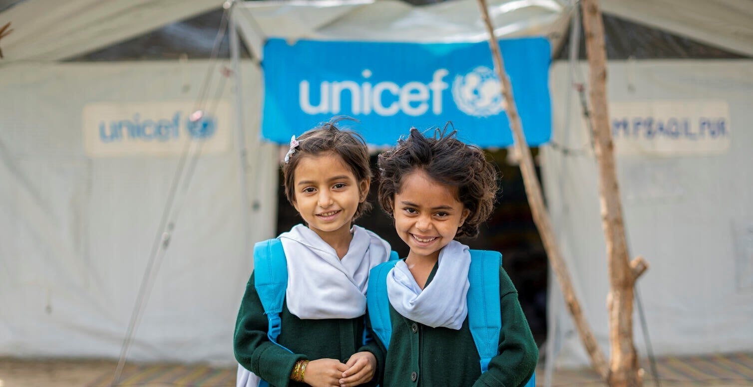 Two school girls out the front of a UNICEF-supported school in Pakistan.