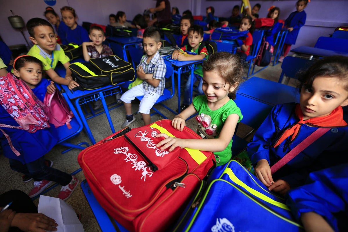 A group of children explore their brand new backpacks
