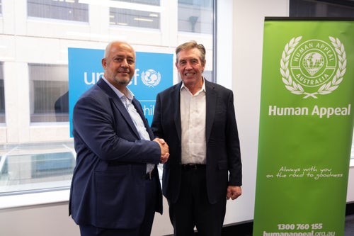UNICEF Australia CEO Tony Stuart and Human Appeal Australia Director Bashar Al‑Jamal shake hands.