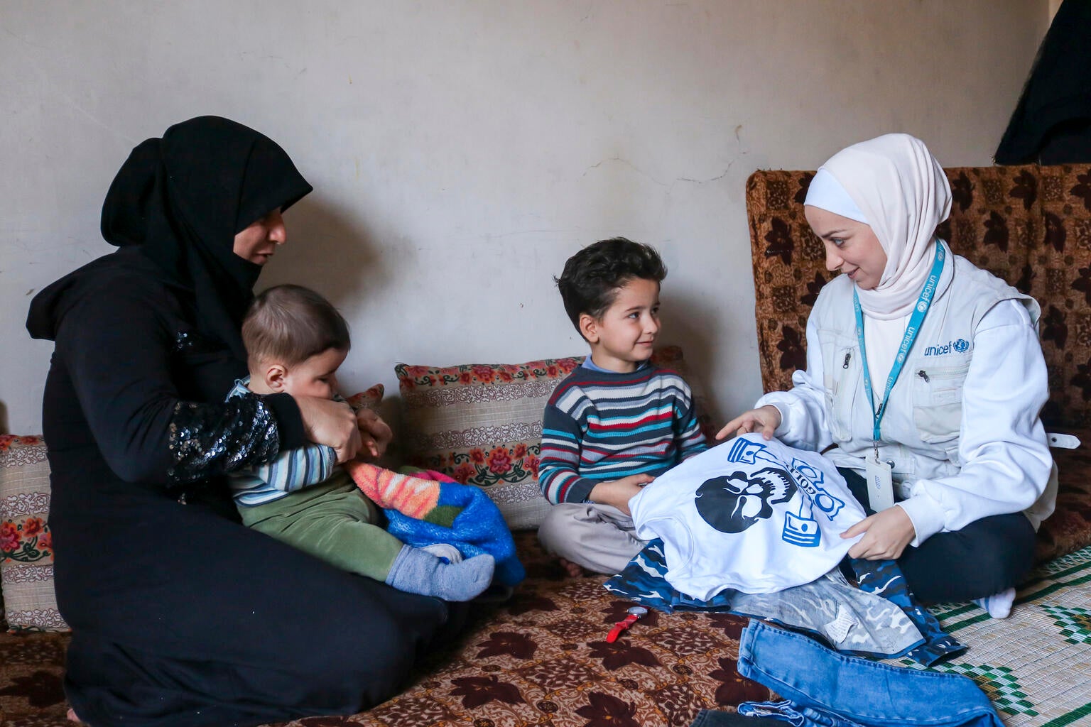 UNICEF worker with a family in Syria. 