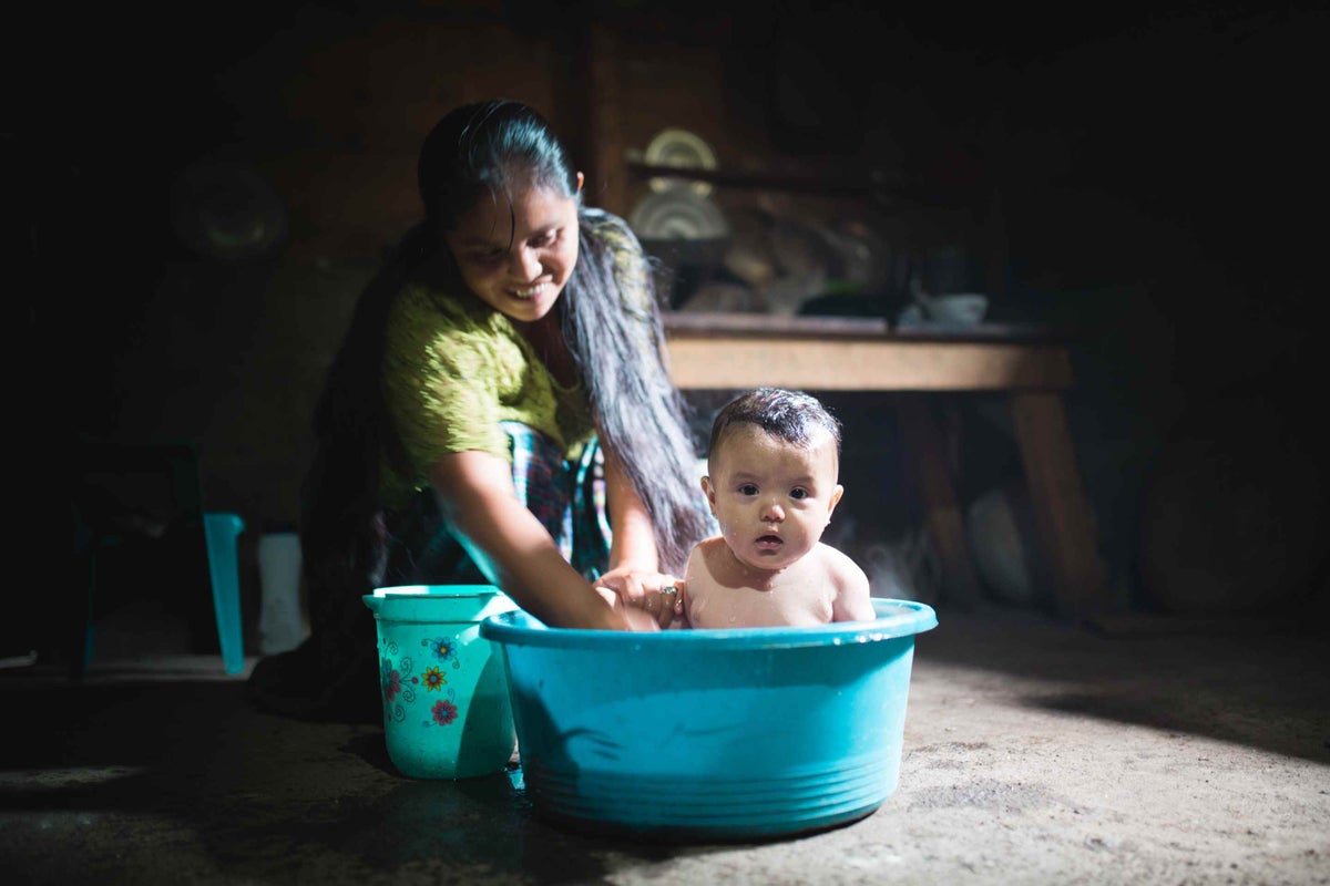 Laura washes her 6-month-old daughter Analí. 