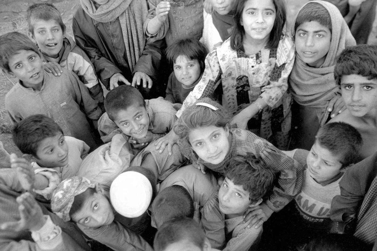 Children crowd around a hand-pump in Laghman, Afghanistan in 2000. 