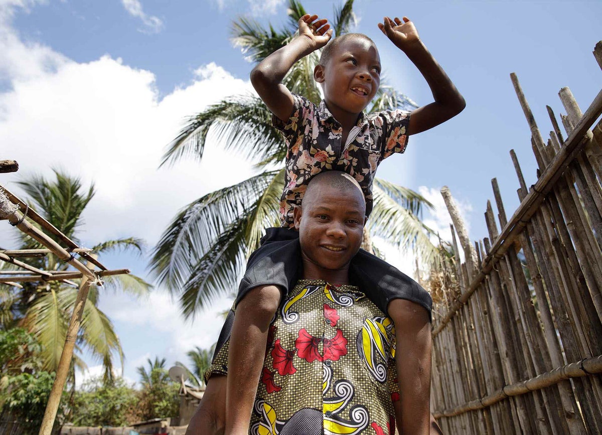 Said and his father are reunited after armed attacks in their village in Mozambique 