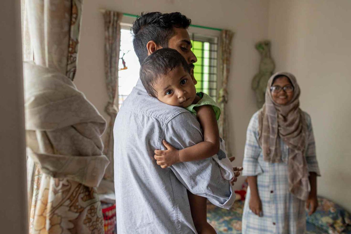Ahmed, 32, holds his daughter, Ayedatujannah, 1, as her mother, Jannatul, 24, looks on, in the family's apartment in Dhaka, Bangladesh.