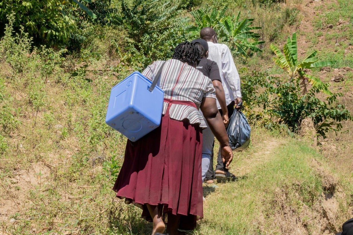 Health officials walking the bad roads in Malawi to make sure that the polio vaccine is given to all the children aged 0 to 5 years.