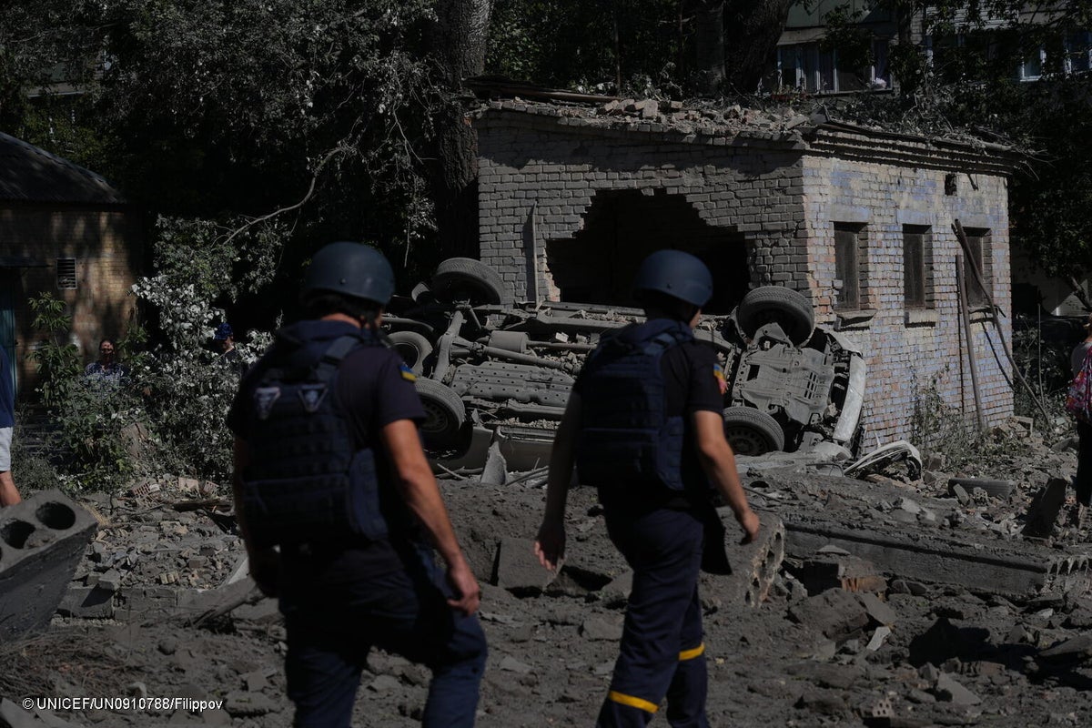 20 August 2026, Kyiv, Ukraine. Emergency workers walk through rubble and debris in Solomianskyi district following attack.