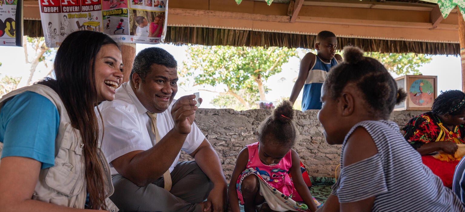 A woman and a man interacting with a child in a learning centre