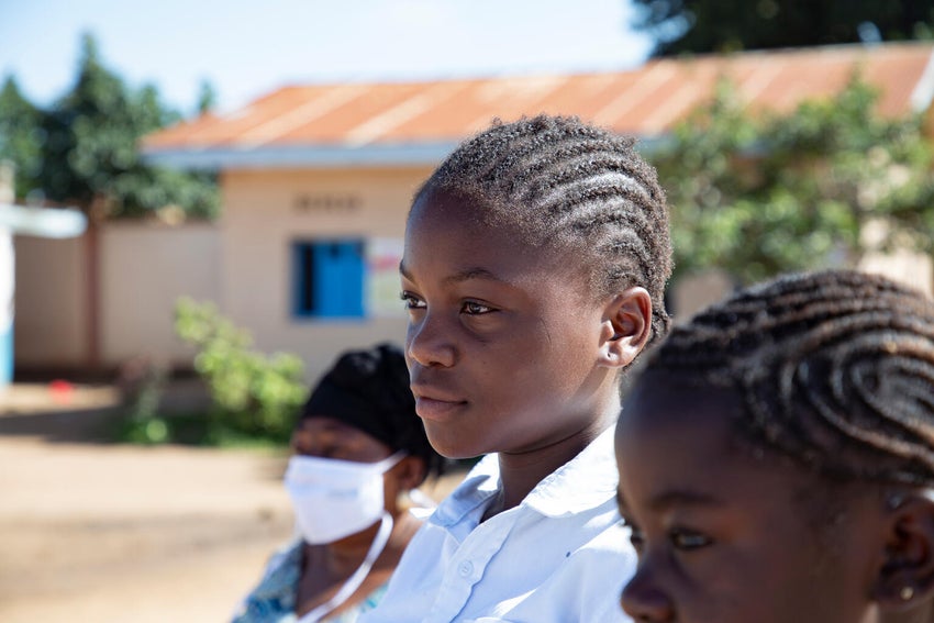 Elongo, 12, listens carefully to UNICEF worker about preventive care during the Ebola 2026 outbreak.