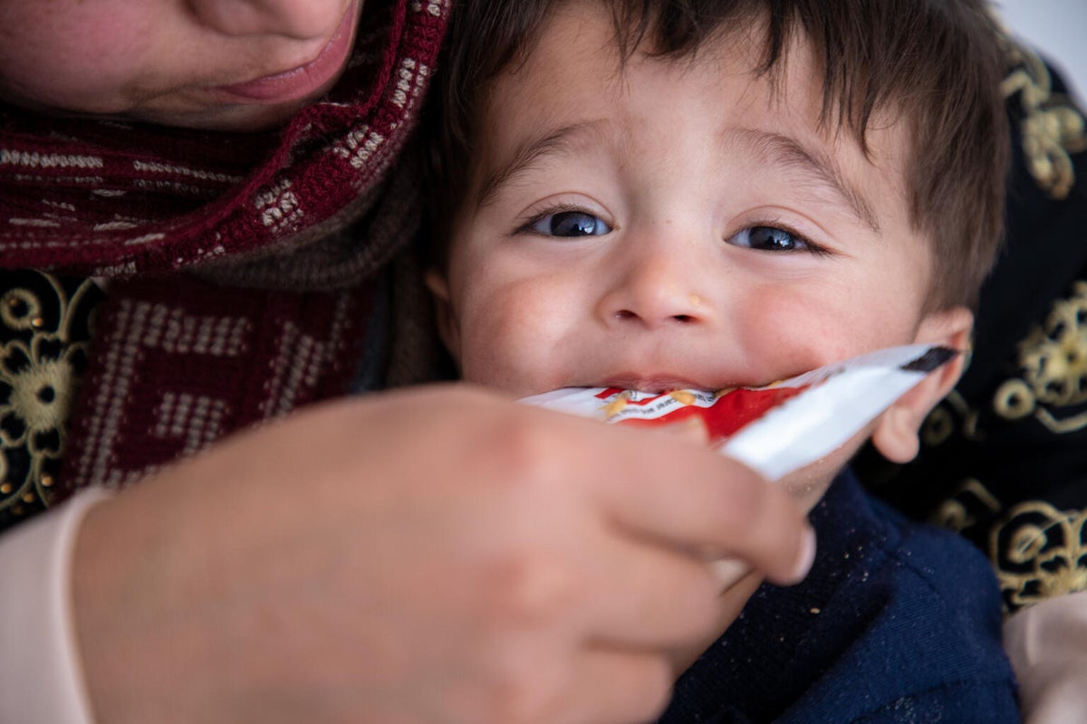 A young boy eating ready-to-use therapeutic food (RUTF).