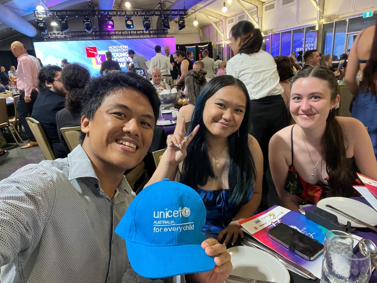 UNICEF Australia Young Ambassador Peter takes a selfie photo with two girls at the 2025 Northern Territory Young Achievers Awards.