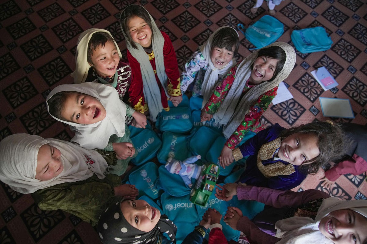 A group of students attend a lesson at the UNICEF-supported Community-based School.
