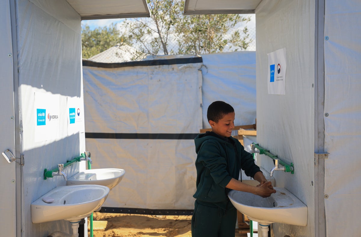 Ahmed, 12, washes his hands at a new water, sanitation and hygiene (WASH) facilities that have been installed at a UNICEF-supported temporary learning centre in Gaza.