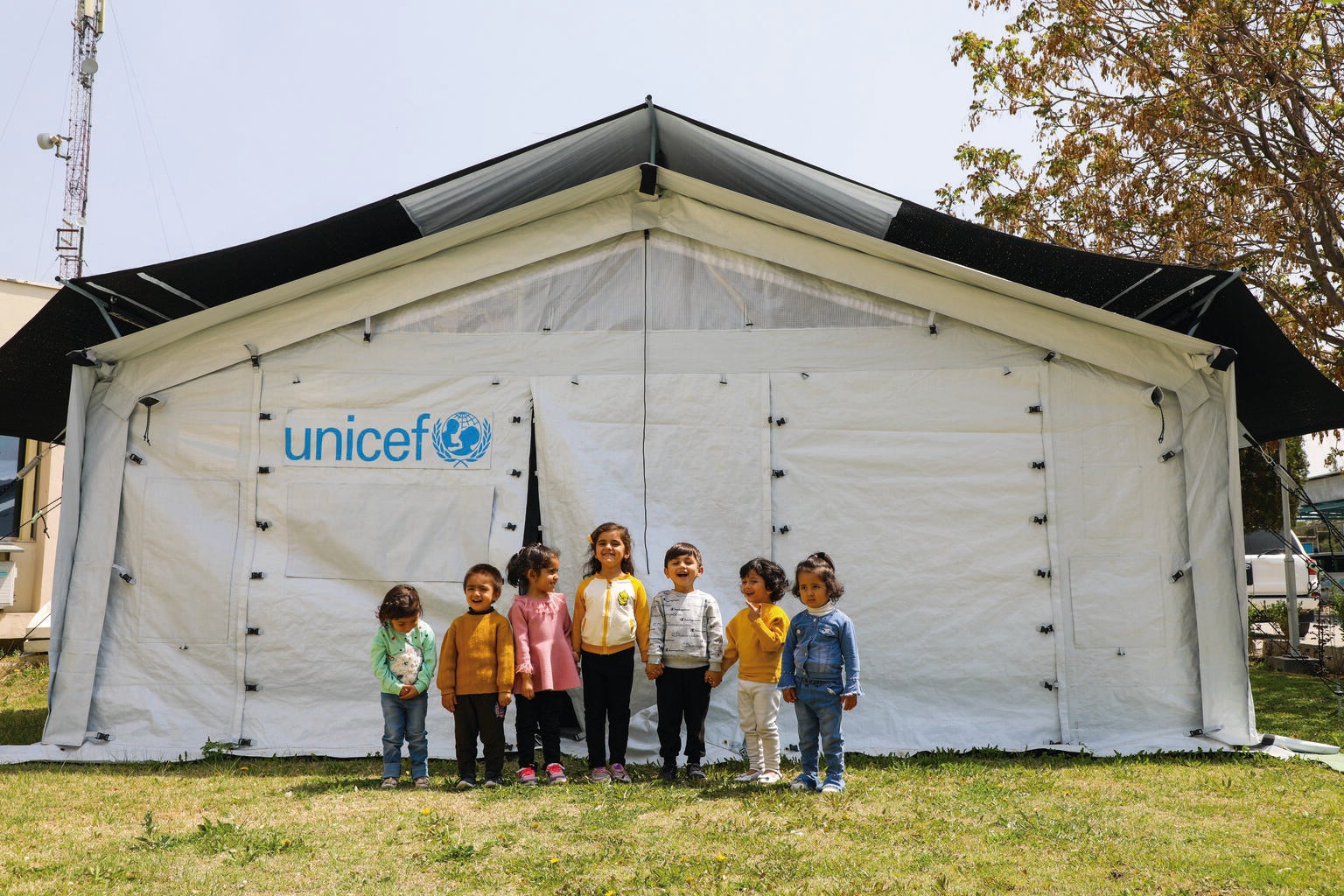 Children play inside and outside the new High Performance Tents, recently installed in Afghanistan to be used for community based education programmes.