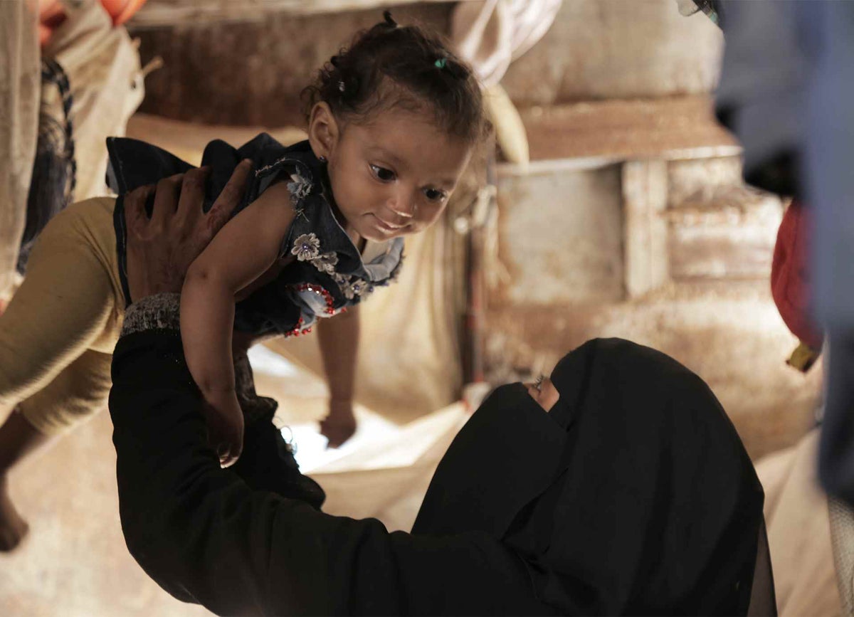 Nour and her mother playing in their humble house