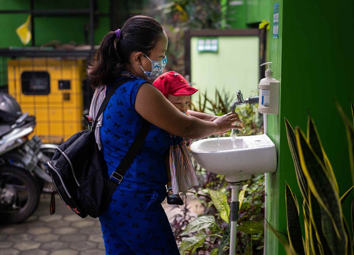 Mother and daughter washing hands