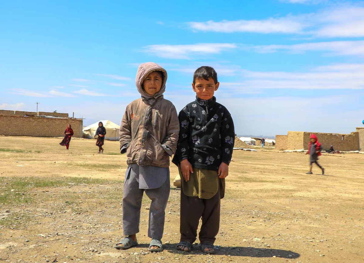 Two boys look towards camera smiling, Afghanistan