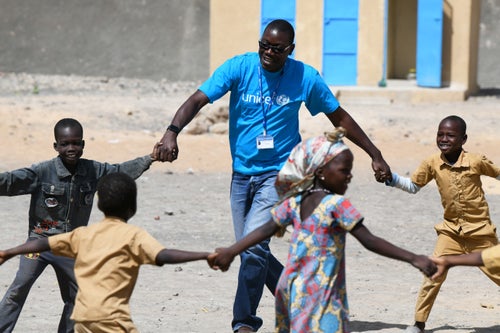 UNICEF Staff member is playing with some children outside at the playground of their school in Boutal Bagara, a suburban of Ndjamena, the capital of Chad. 