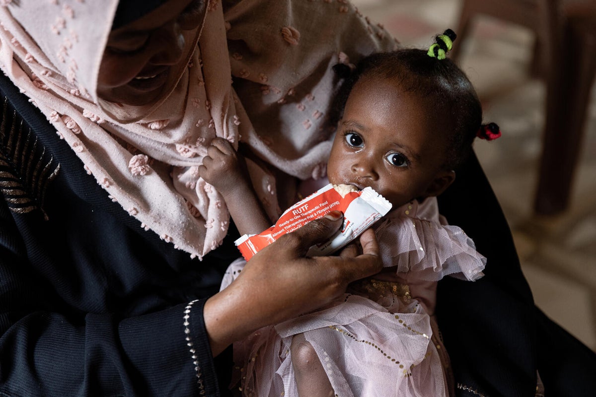 A young girl suffering from malnutrition is being treated with Ready-to-use Therapeutic Food (RUTF).