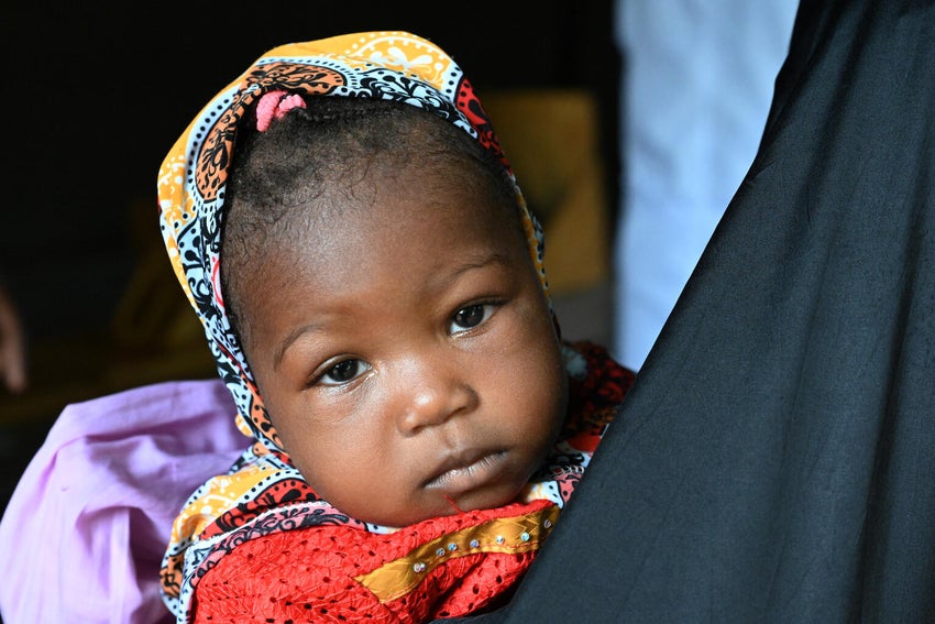 A baby looks at the camera.