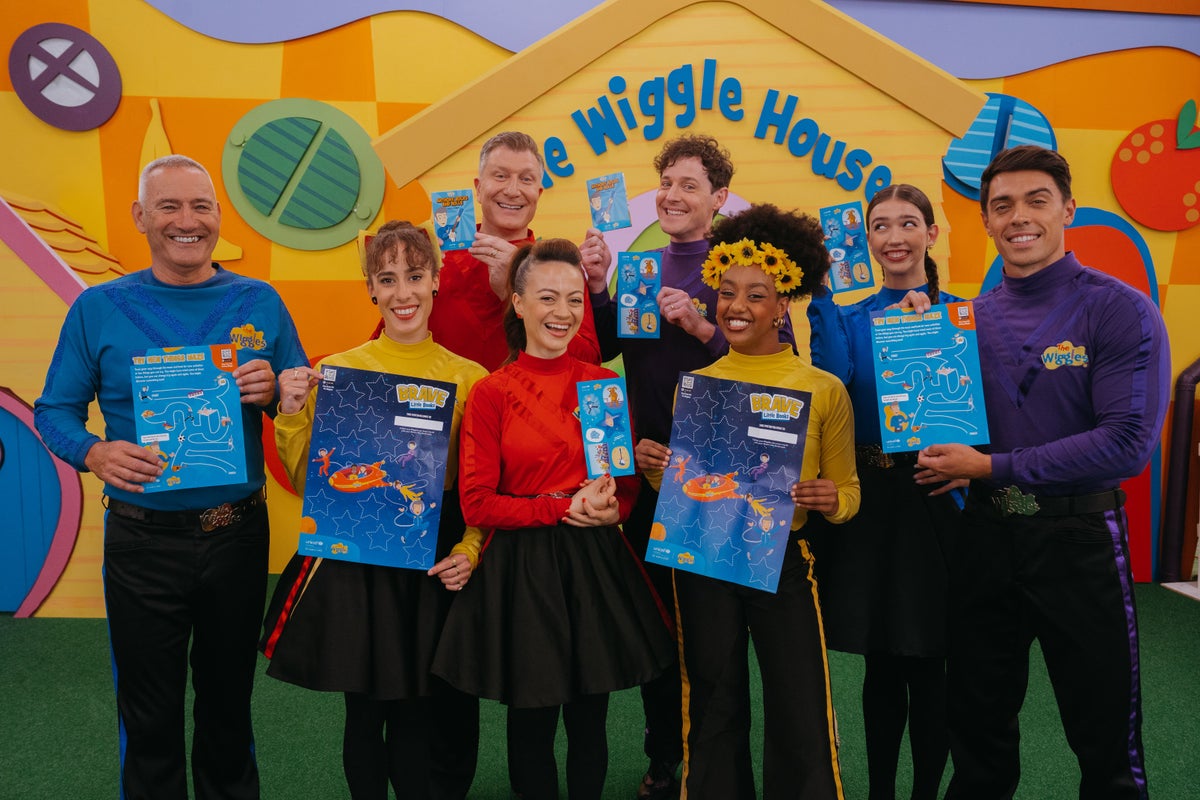 The Wiggles holding The Wiggles Brave Little Books activity packs.