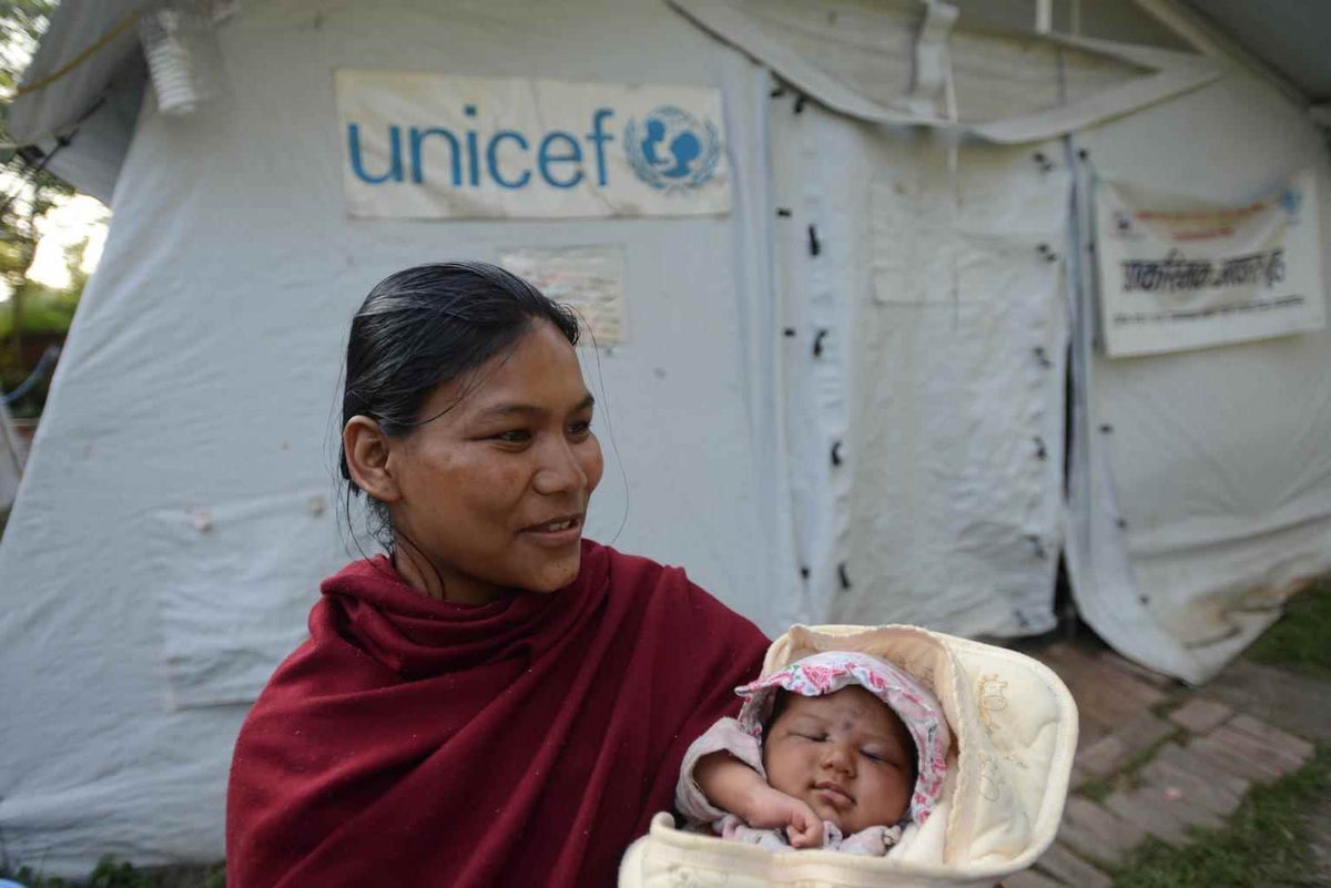 Rupa Shrestha holds her newborn daughter in a UNICEF-supported shelter for pregnant and new mothers after Nepal’s earthquakes in 2015. 
