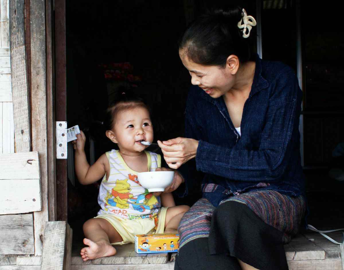 Mother feeds her child