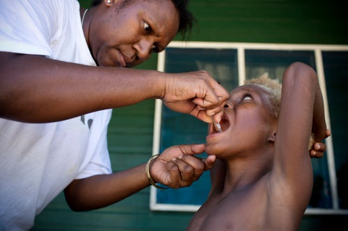 Health care worker giving child a vaccine