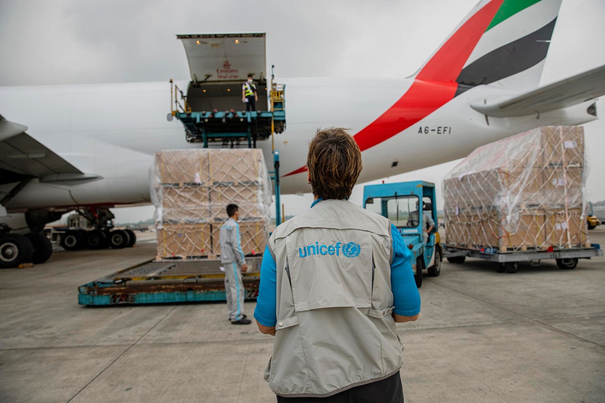 A UNICEF representative waiting for COVID-19 vaccines to be offloaded from the cargo plane in Vietnam.
